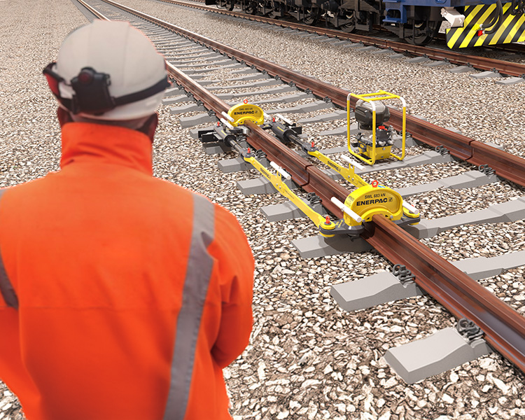 Construction worker with hard hat and safety gear next to a yellow ladder