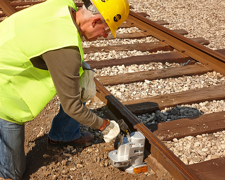 Construction worker with hard hat and safety gear next to a yellow ladder